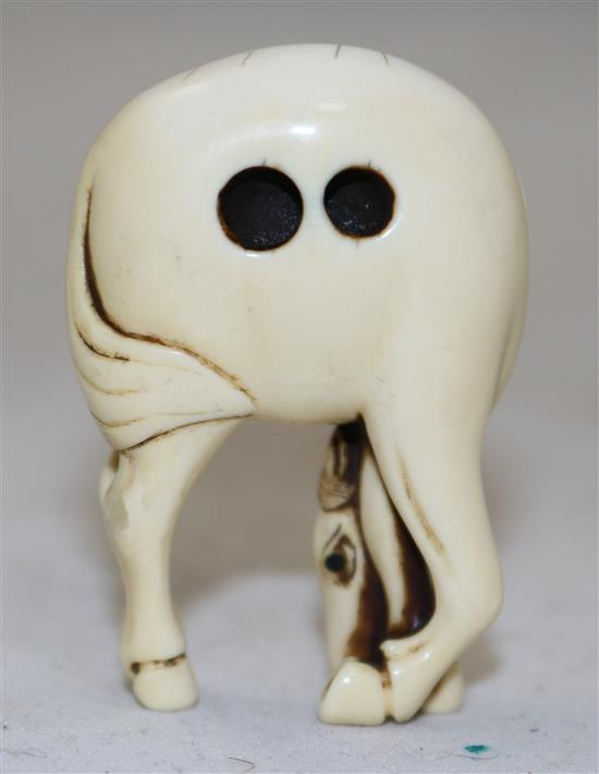 A Japanese stag antler netsuke of a horse, 18th/19th century, 4.9cm